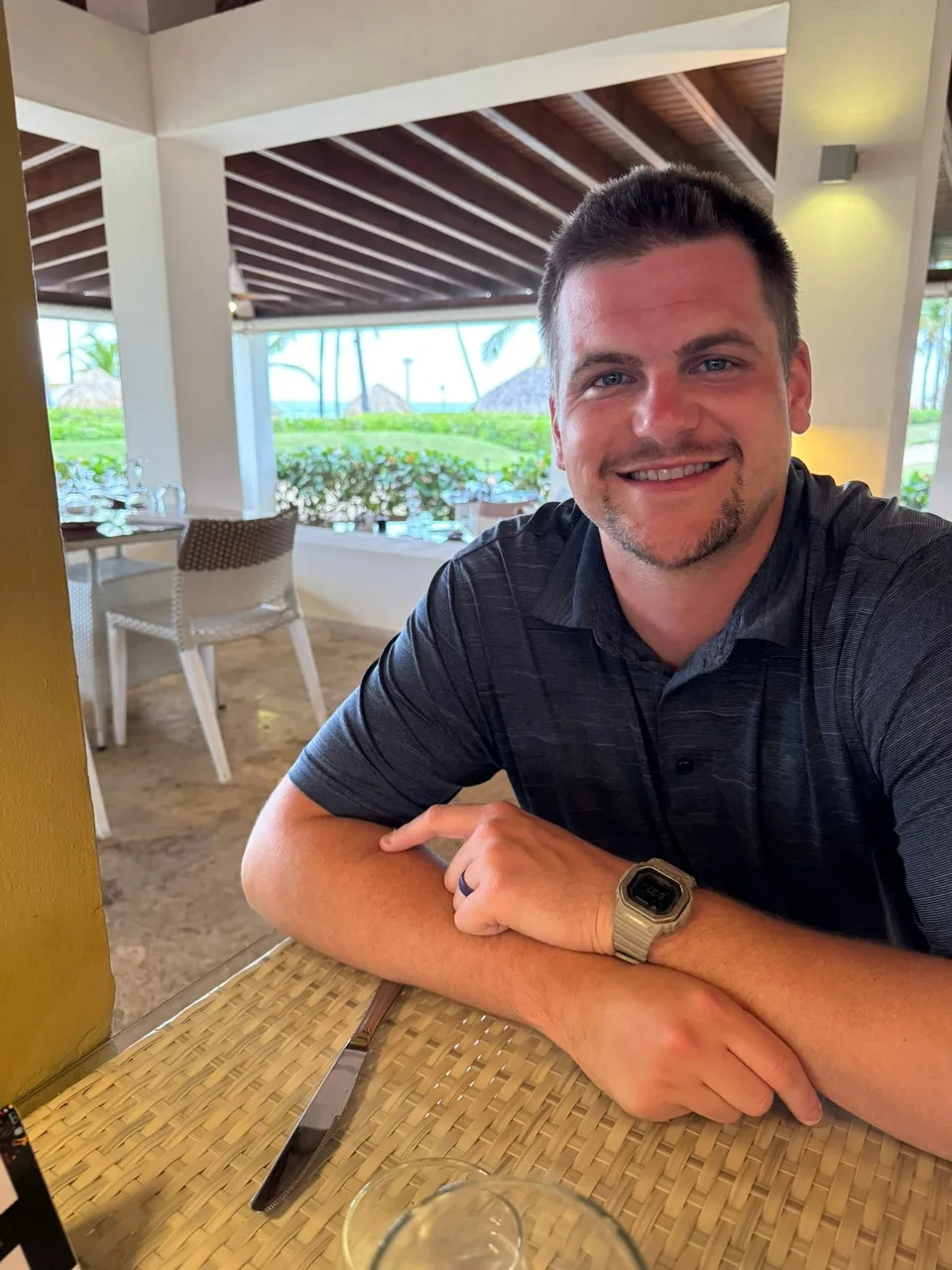Kinnon Roudebush smiling at an outdoor table
