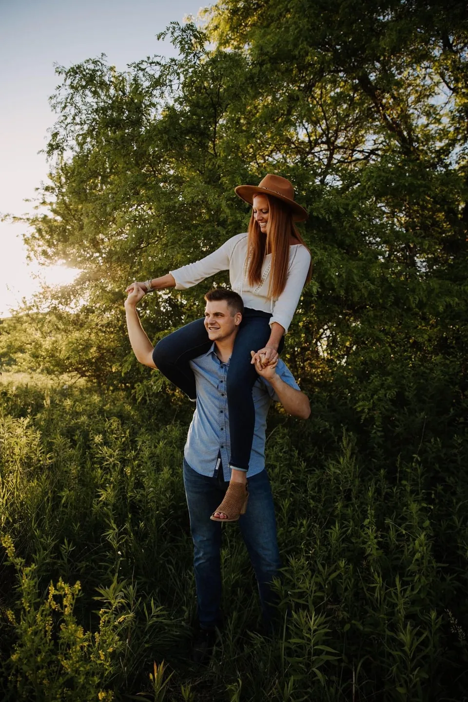 Kinnon carrying Mariah on his shoulders outdoors